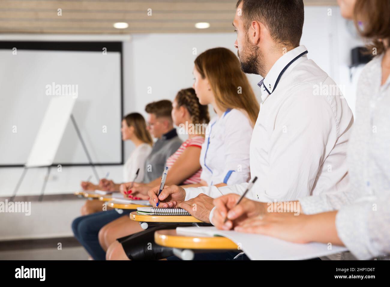 Auditorium. View Side view of young people in auditorium Stock Photo - Alamy