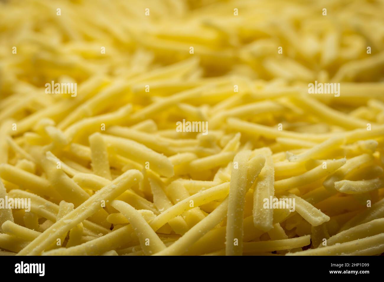 grated cheddar cheese background closeup Stock Photo Alamy
