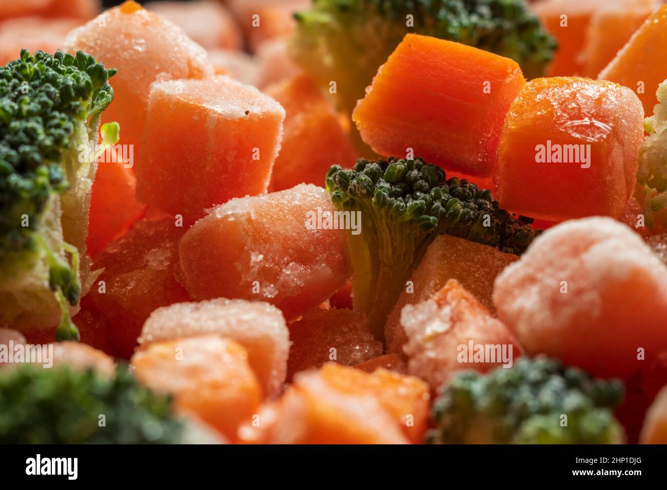 Frozen carrots broccoli pieces closeup background Stock Photo Alamy