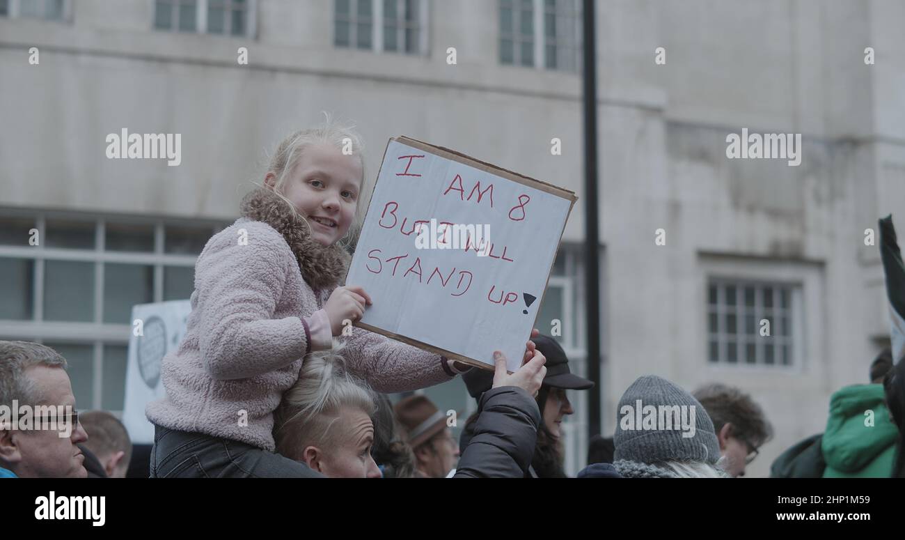 London, UK - 01 22 2022:  A young child holding a sign amongst a crowd of protesters, ‘Please Don’t Fire My Mummy’, a NHS health worker. Stock Photo