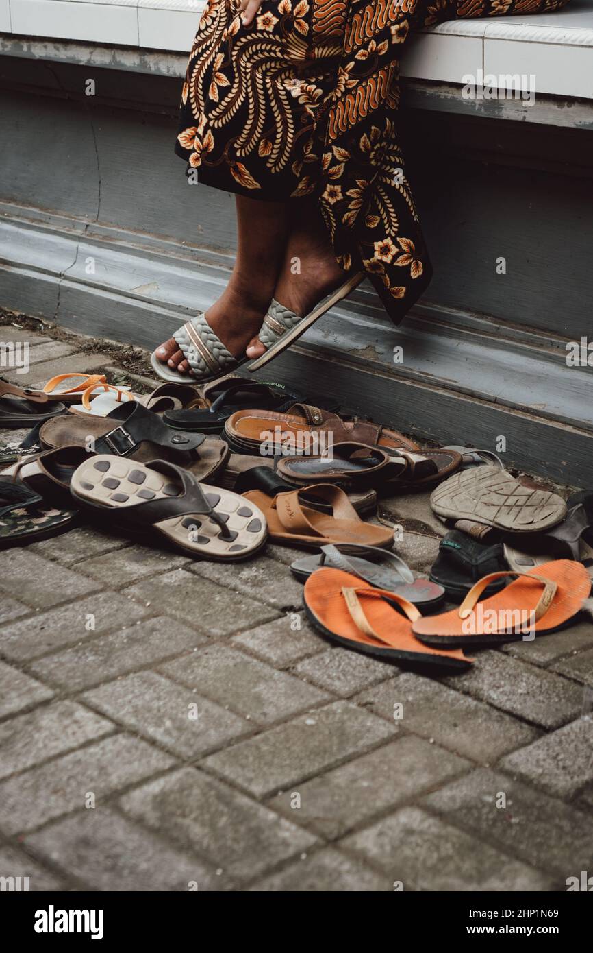 Take off your shoes before entering Bali temple Stock Photo - Alamy