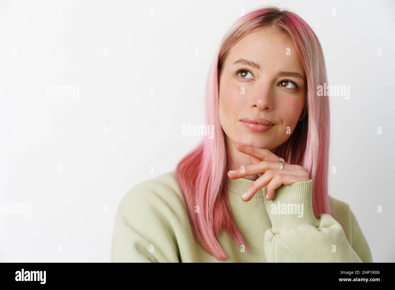 Young white thinking woman with pink hair looking upward isolated over ...