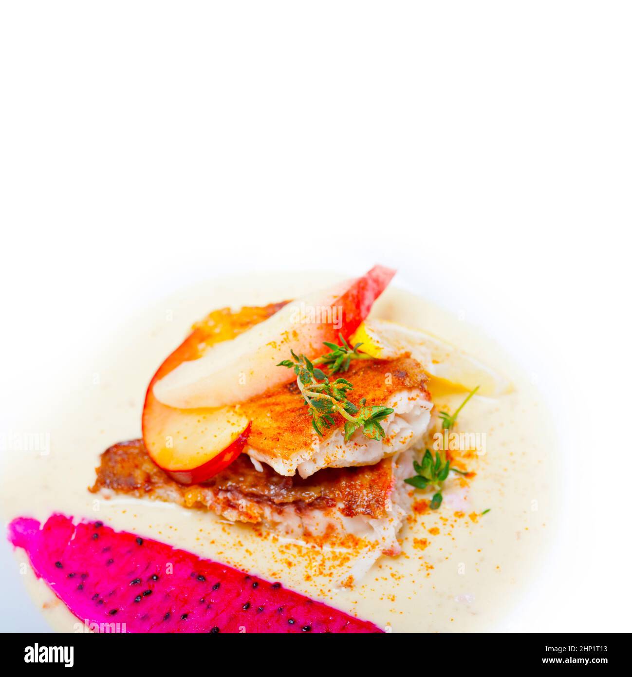 sea bream orata  fillet butter pan fried with fresh peach prune and dragonfruit slices thyme on top Stock Photo