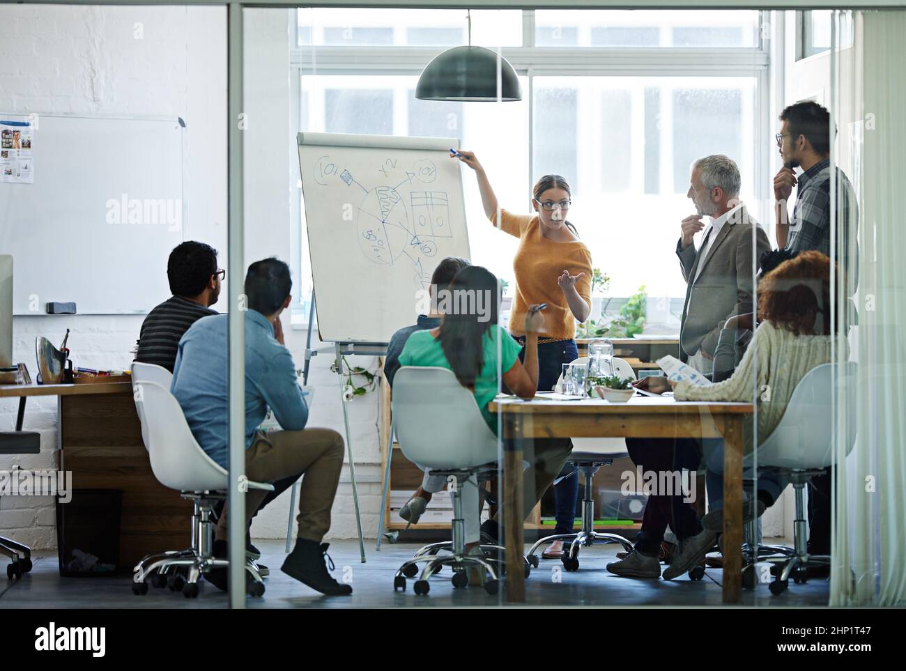 Im open to all ideas. Shot of a group of coworkers in a boardroom meeting. Stock Photo