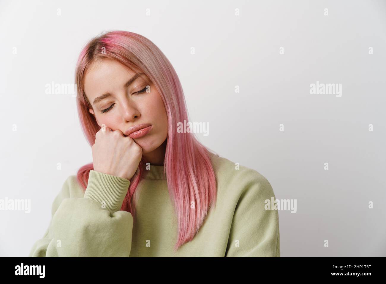 Young white woman sleeping while propping up her head isolated over