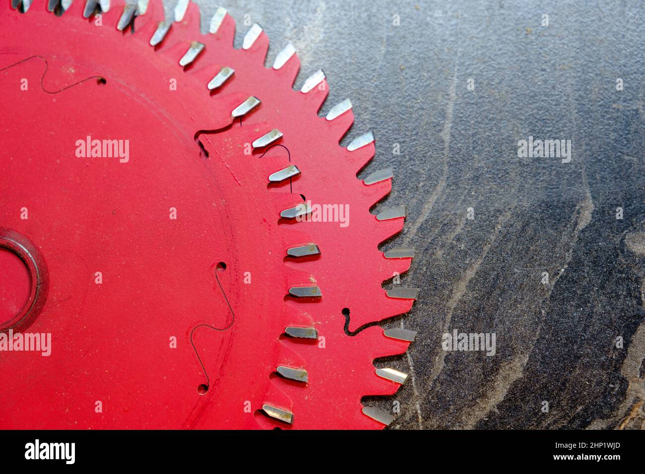 Two red spare blades for circular saw on wooden surface, furniture manufacturing, selective focus Stock Photo