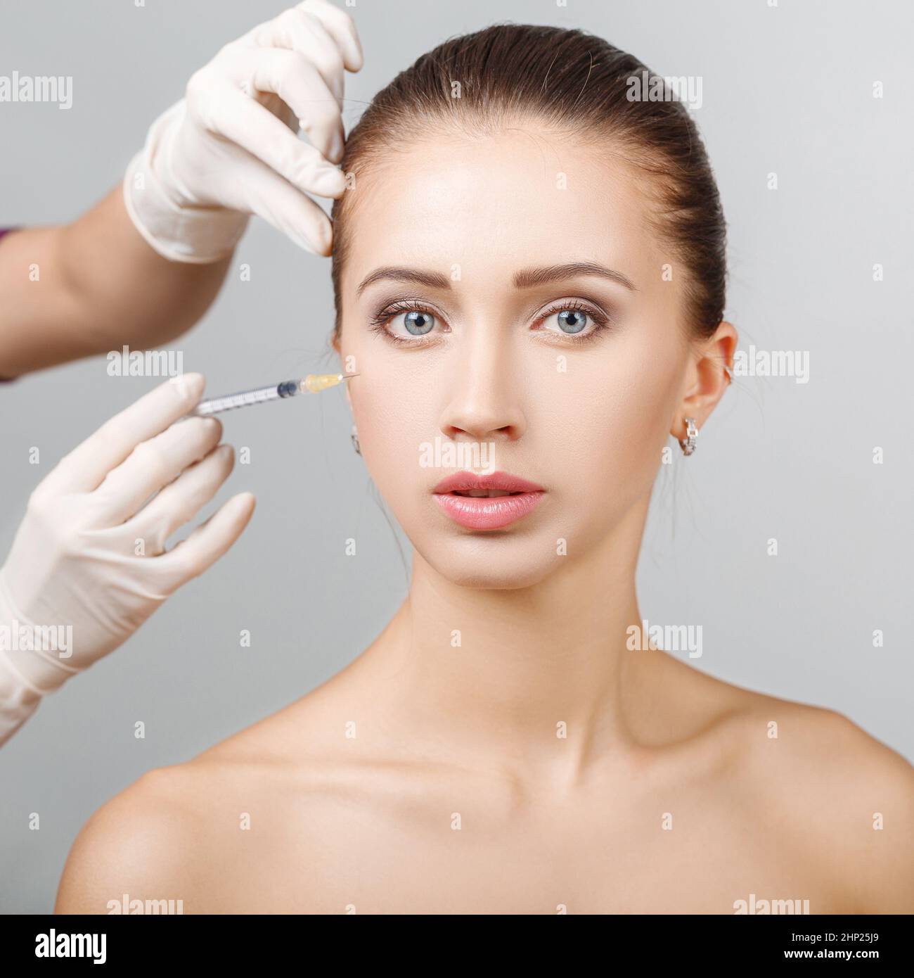 Portrait of young beautiful woman getting cosmetic lifting injection in ...
