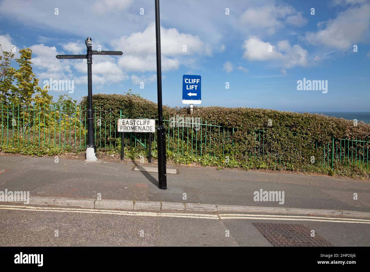 Path next to a hedgerow, with a lamp post and road signs Stock Photo ...