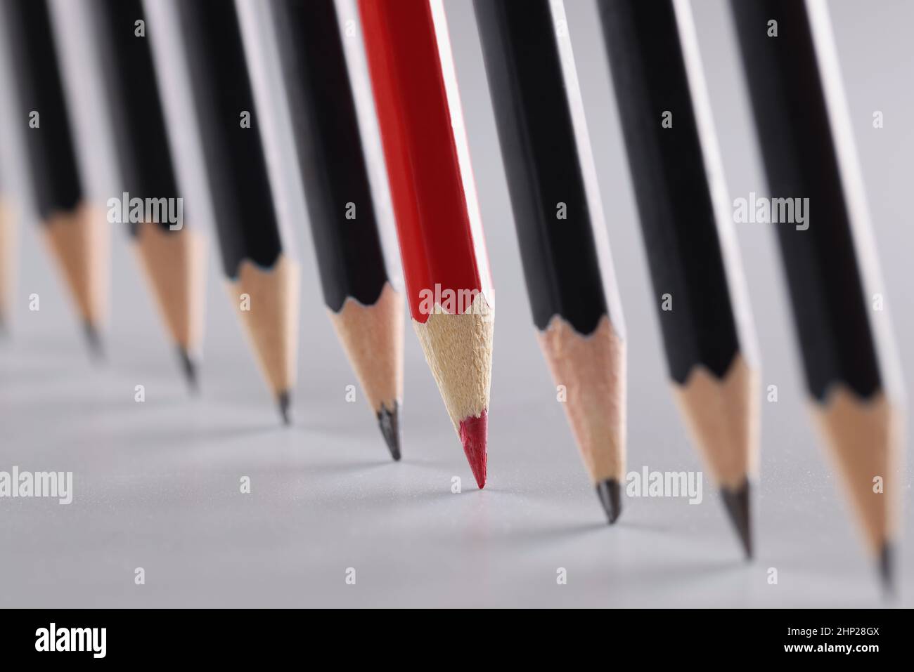 Sharp pencils in a row on a gray background Stock Photo