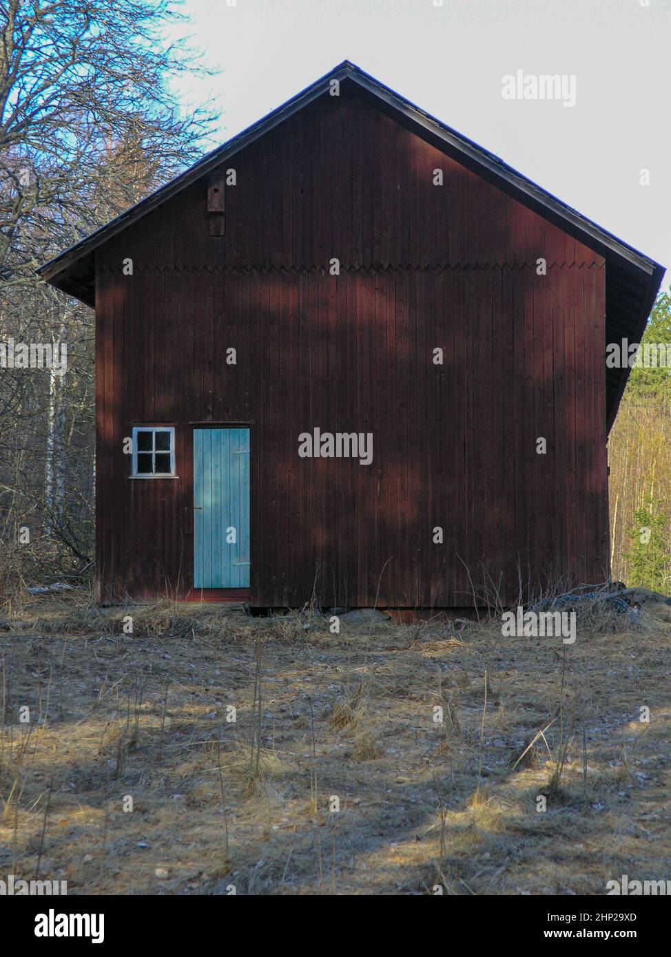 Old wooden door and small window on side of a red barn Stock Photo - Alamy