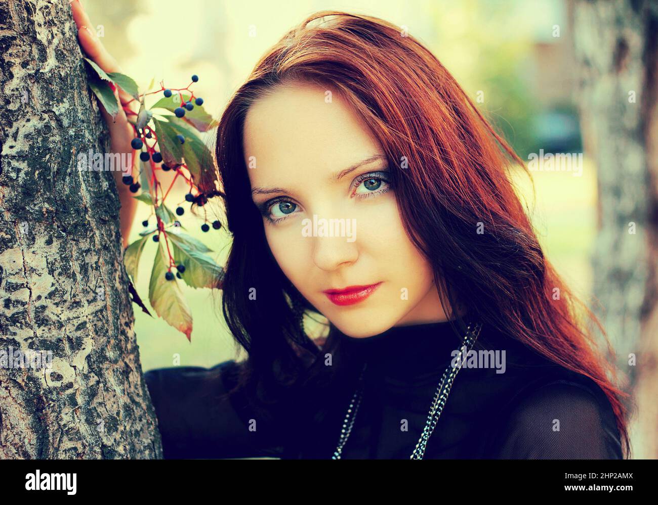 Portrait of beautiful young girl with red hair at a tree Stock Photo ...