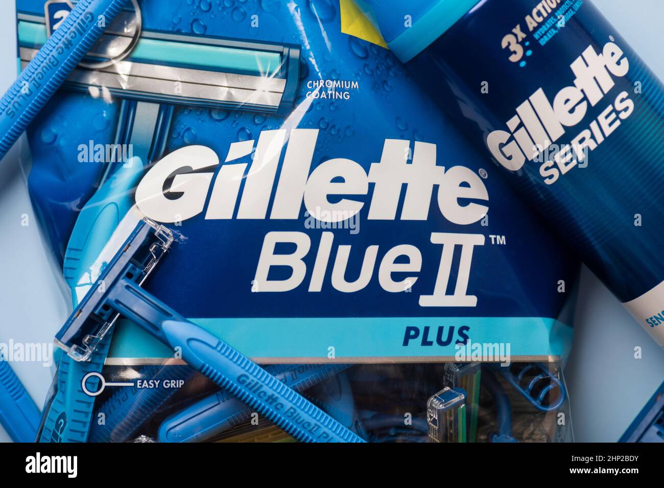 Closeup of package of Gillette Blue 2 razors and shaving foam can with Gillette Series logo lettering over blue background Stock Photo