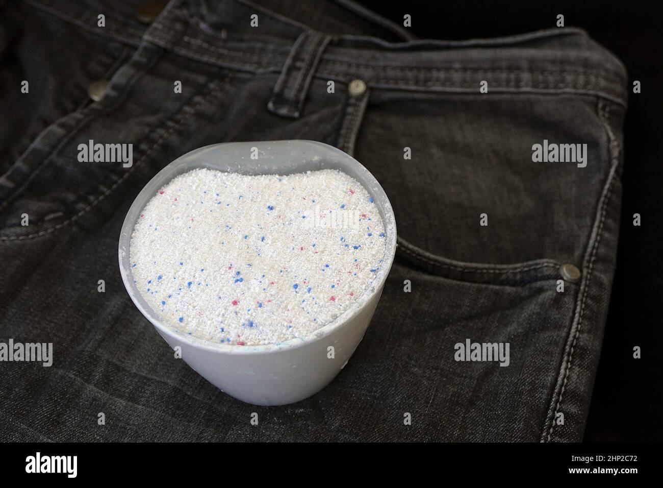 along with black jeans and a measure of laundry detergent Stock Photo -  Alamy