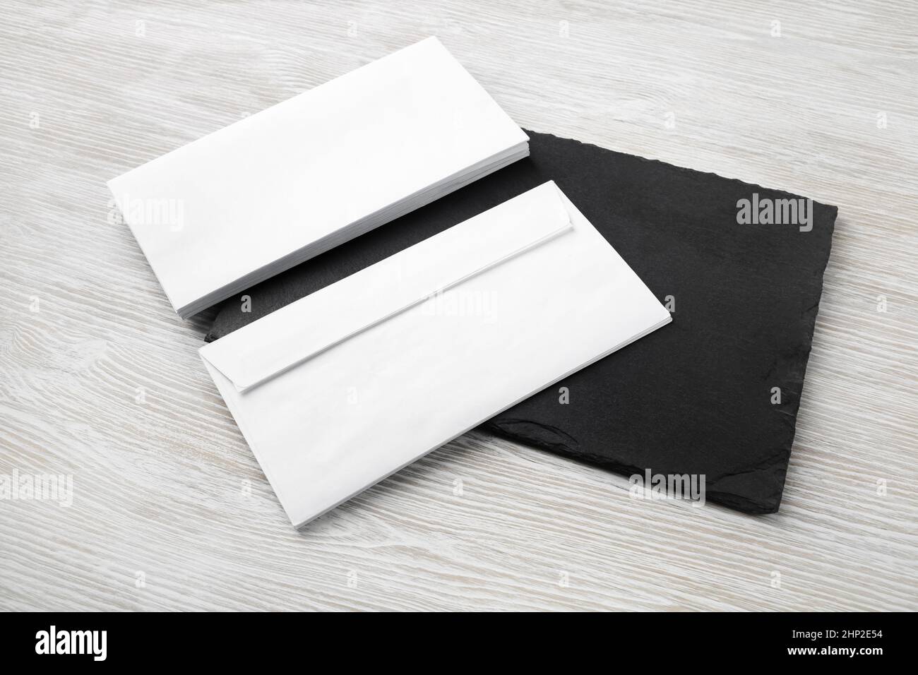 Two blank envelopes on stone board. Copy space. Responsive design template. Stock Photo