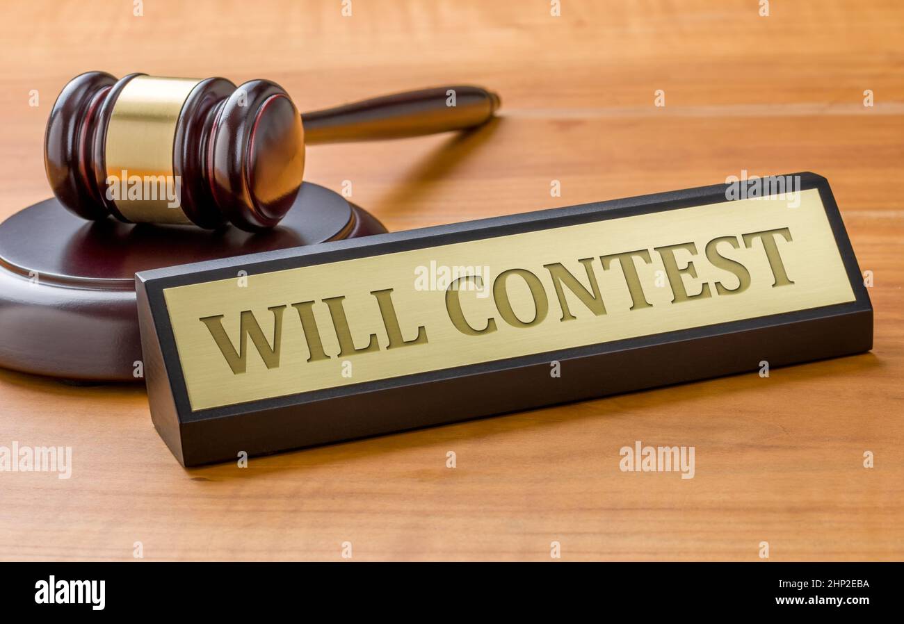 A gavel and a name plate with the engraving Will contest Stock Photo