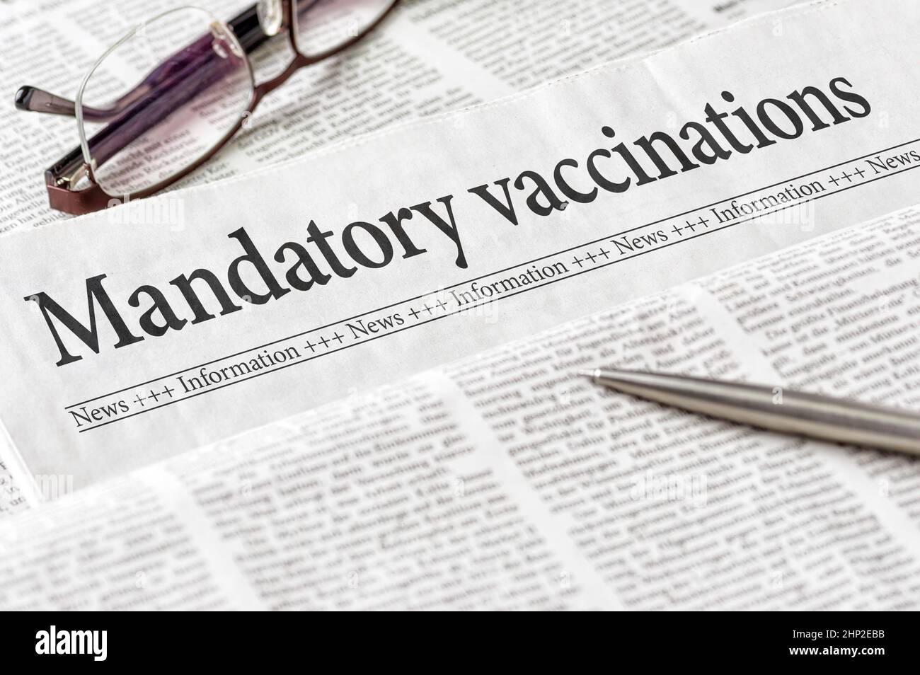 A newspaper with the headline Mandatory vaccination Stock Photo