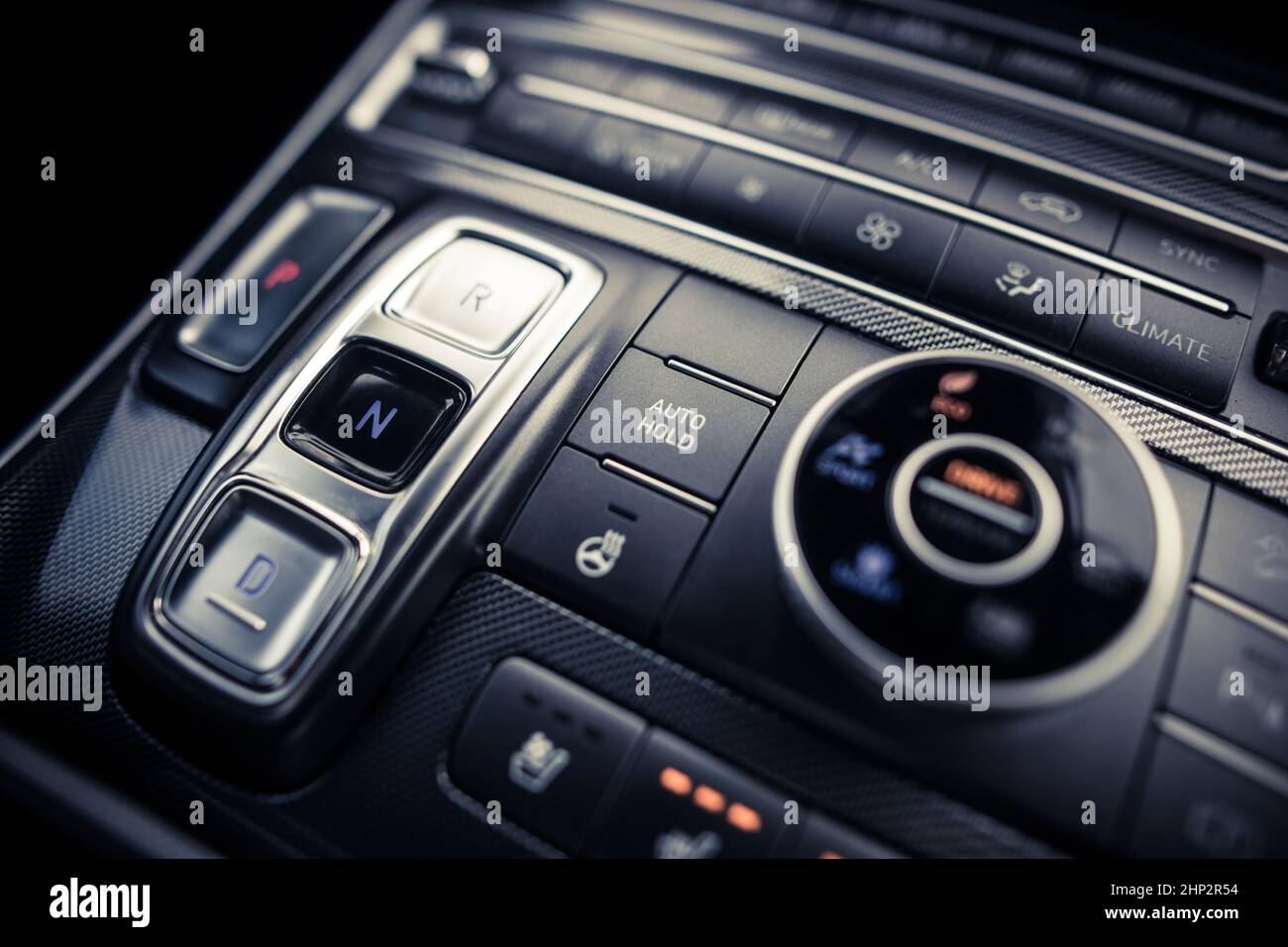 Close up shot of an automatic button gear shifter on a central console in a new car. Stock Photo