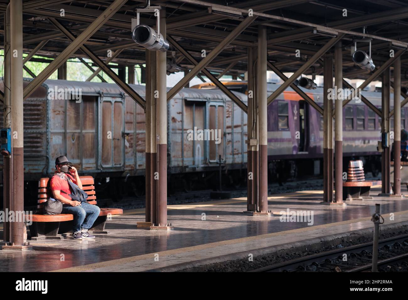 A lone passenger waiting for his train on a platform at Hualamphong Station (Hua Lamphong Stn.), Bangkok, Thailand Stock Photo