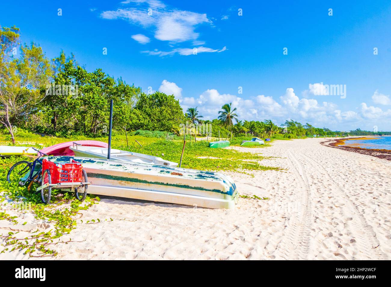 Boats canoes and bicycle at tropical mexican beach panorama view with