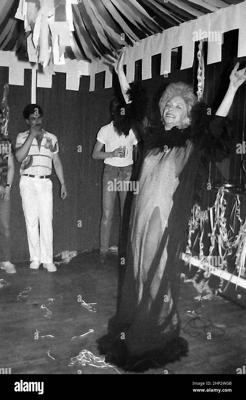 Drag artiste Barry Stevens performing at gay bar Stuffed Olives, Manchester, Greater Manchester, England, United Kingdom, in 1983. Daily life in the night life of Manchester's gay clubs and bars in the 1980's. A performer on the stage in a bar or public house popular with lesbians and gay men or LGBT people in  in the early 1980s. Stock Photo