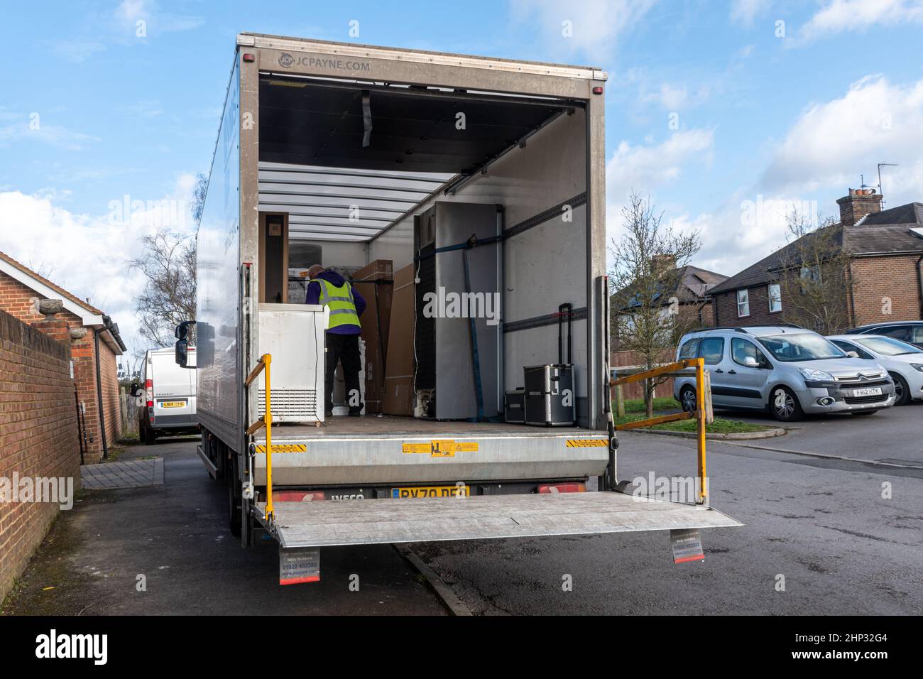Electrical appliances in the back of a delivery van with, UK. White goods being transported and delivered. Stock Photo