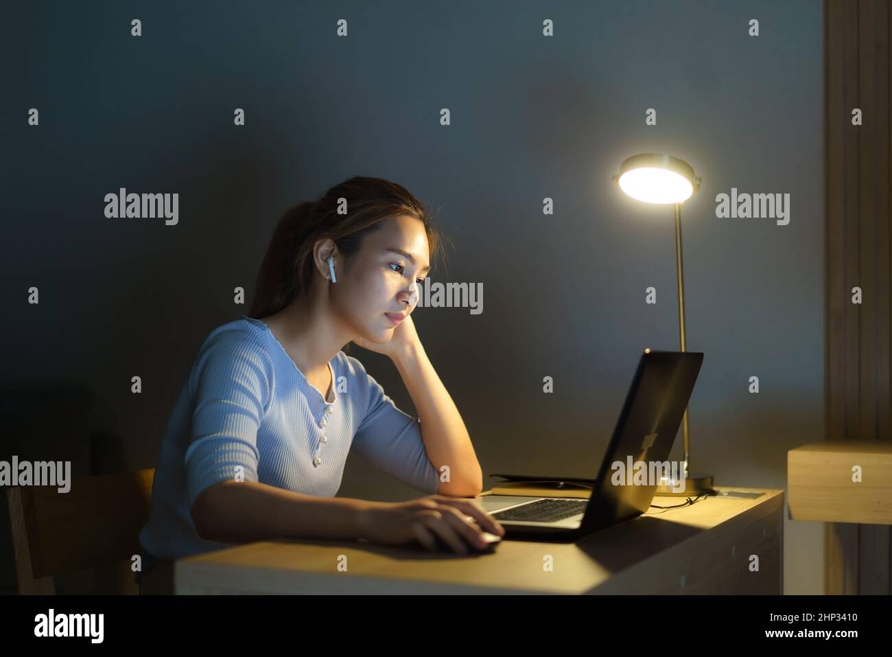 Asian business woman stress out with project business plan on computer laptop or notebook at home office at night. Asian people occupational burnout s Stock Photo