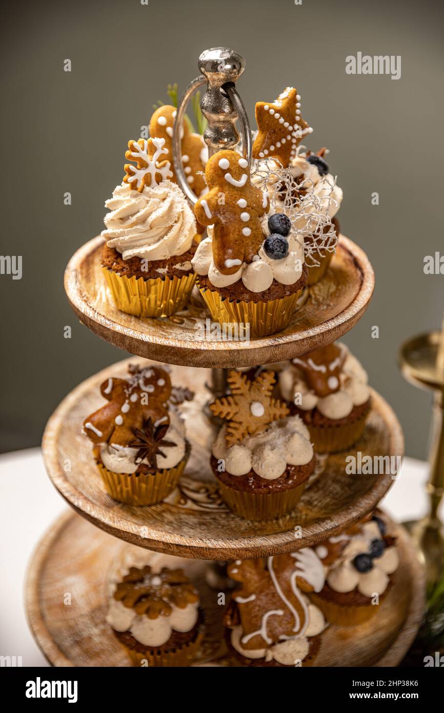 Christmas gingerbread cupcakes with creamy spiced frosting on the cake stand Stock Photo