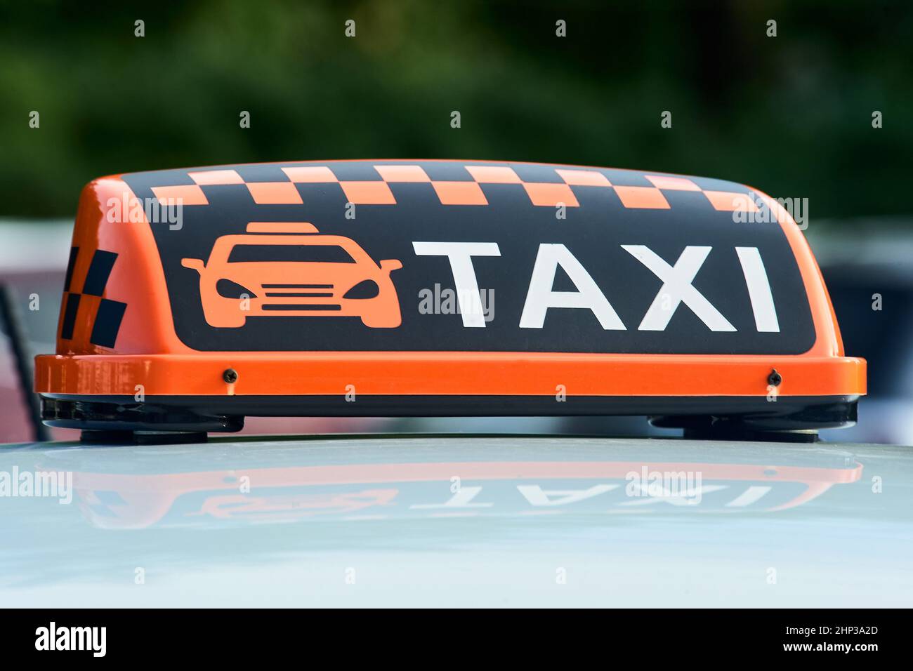 an orange taxi sign stands on the roof of the car. High quality photo Stock Photo