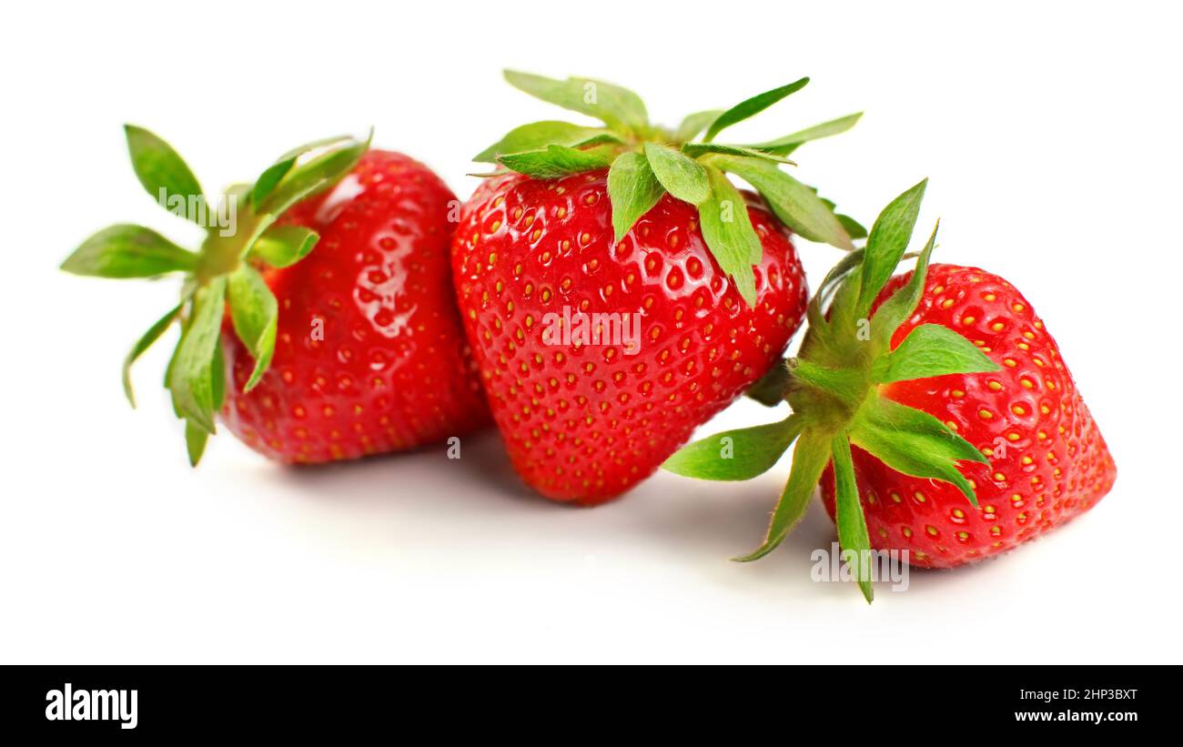 Three ripe strawberries isolated on white background Stock Photo - Alamy