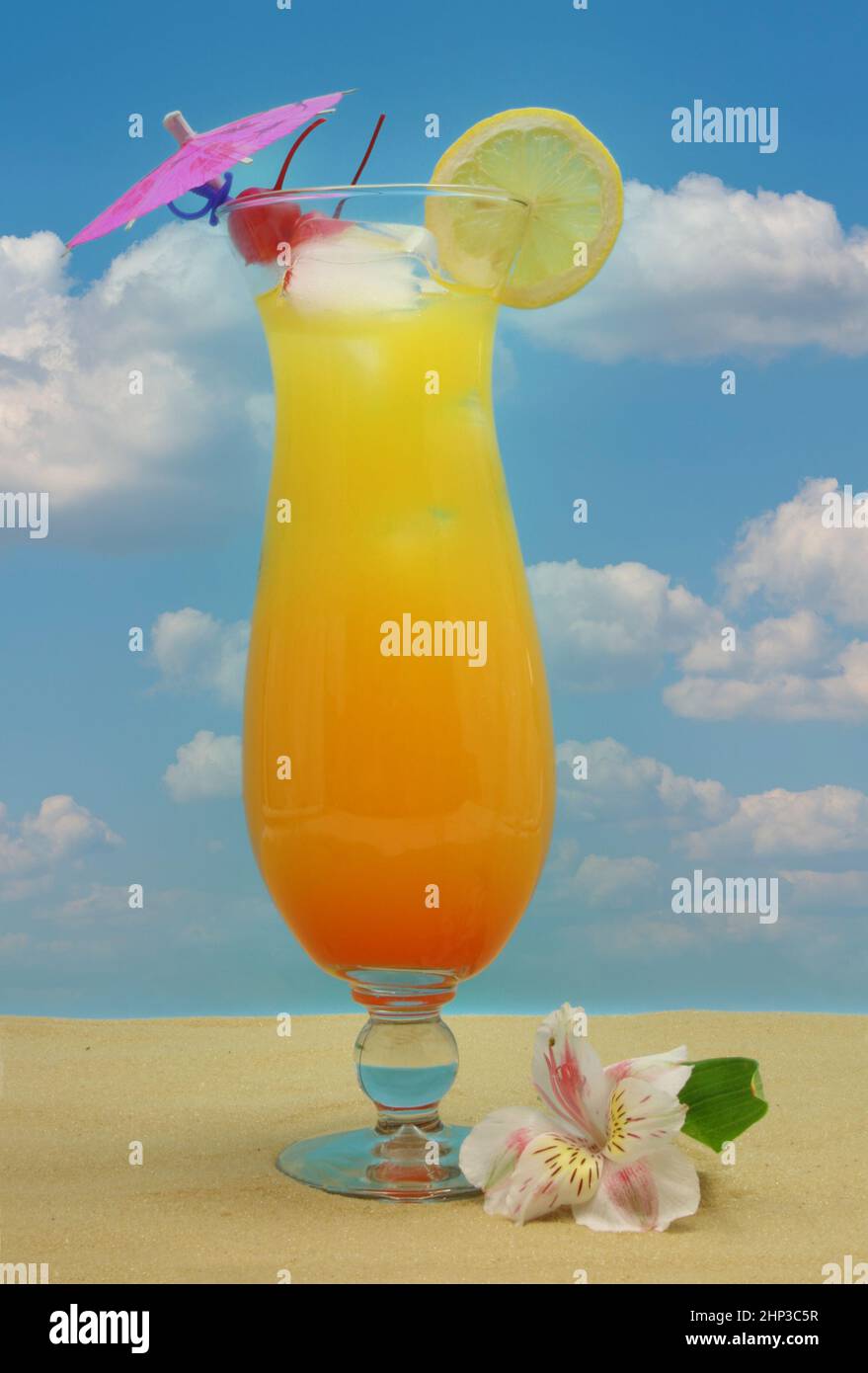 Pineapple, Tropical Drink and Fruit on Sand With Sky Background Stock