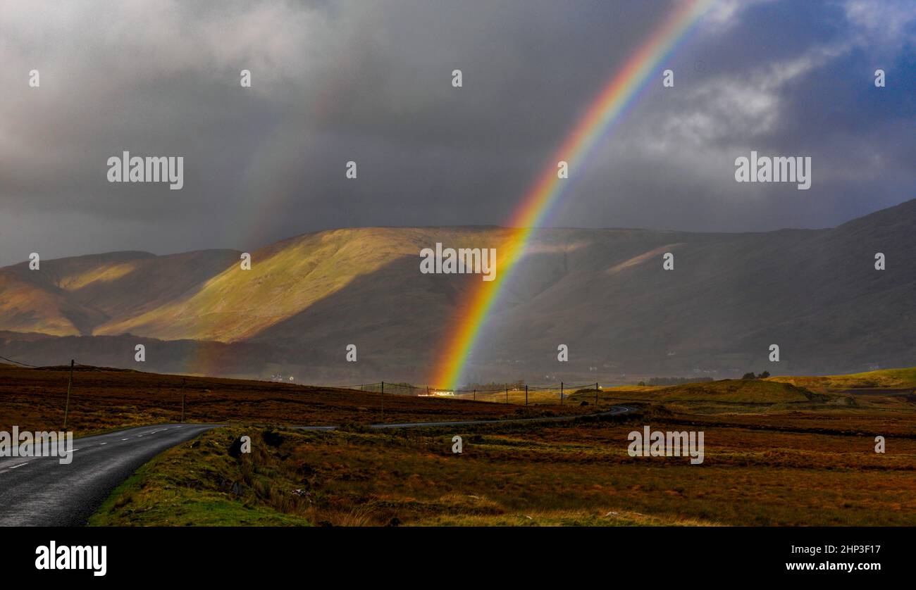 Rainbow on the road from Maam Cross to Maam, Connemara, County Galway, Ireland Stock Photo