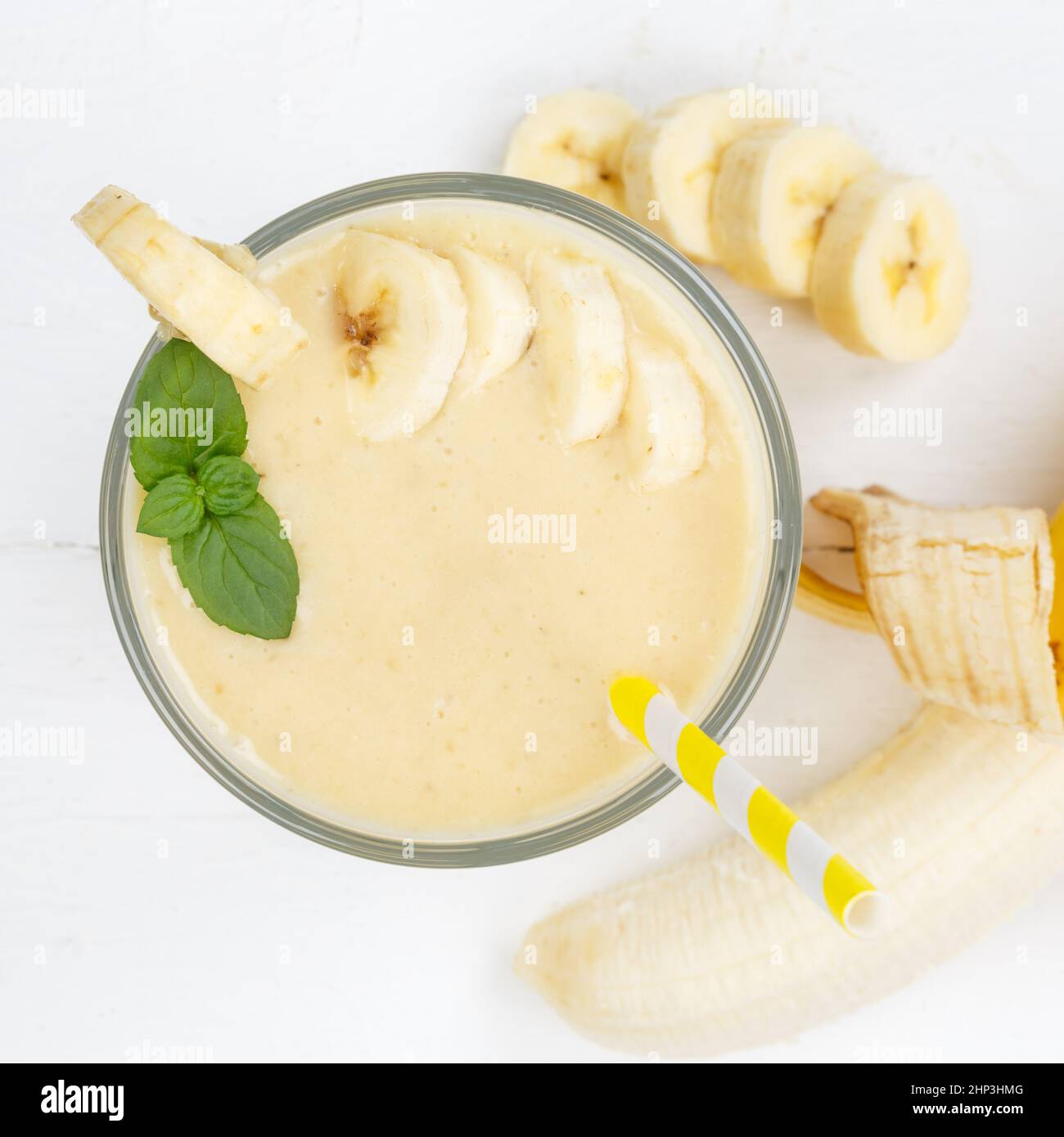 Banana fruit juice smoothie fresh drink in a glass from above square healthy drinking Stock Photo