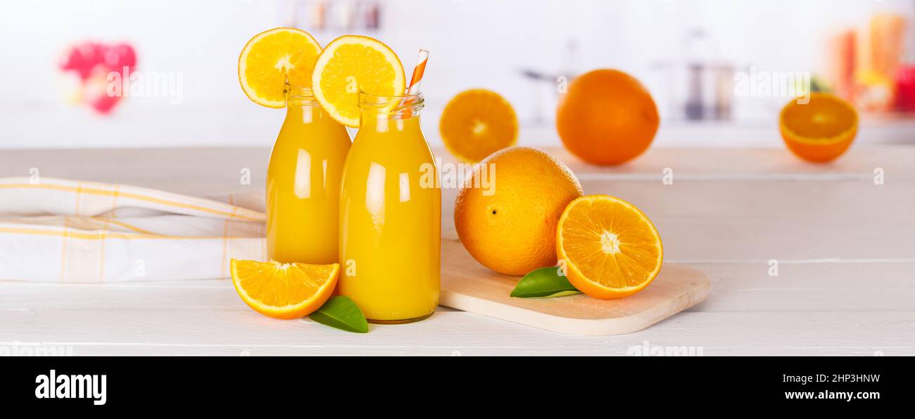 Orange juice drink in bottle on wooden board panorama copyspace copy space oranges Stock Photo