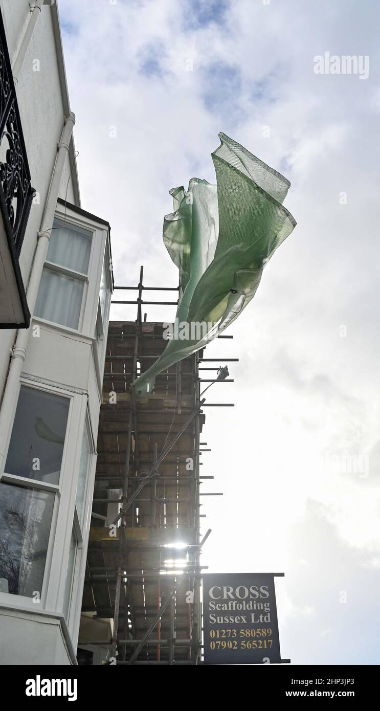 Brighton, UK 18th February 2022 - Building work covers blowing in the wind in Brighton as Storm Eunice batters Britain today with a red warning being issued for the South West and South East  : Credit Simon Dack / Alamy Live News Stock Photo