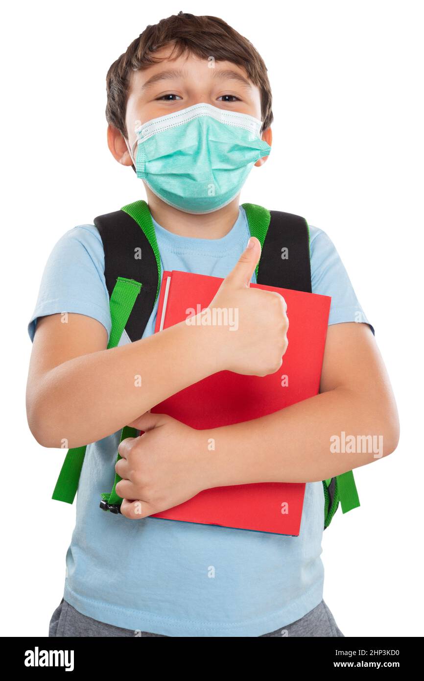 Young student child kid little boy wearing face mask against Coronavirus showing thumbs up Corona Virus COVID-19 Covid isolated on a white background Stock Photo