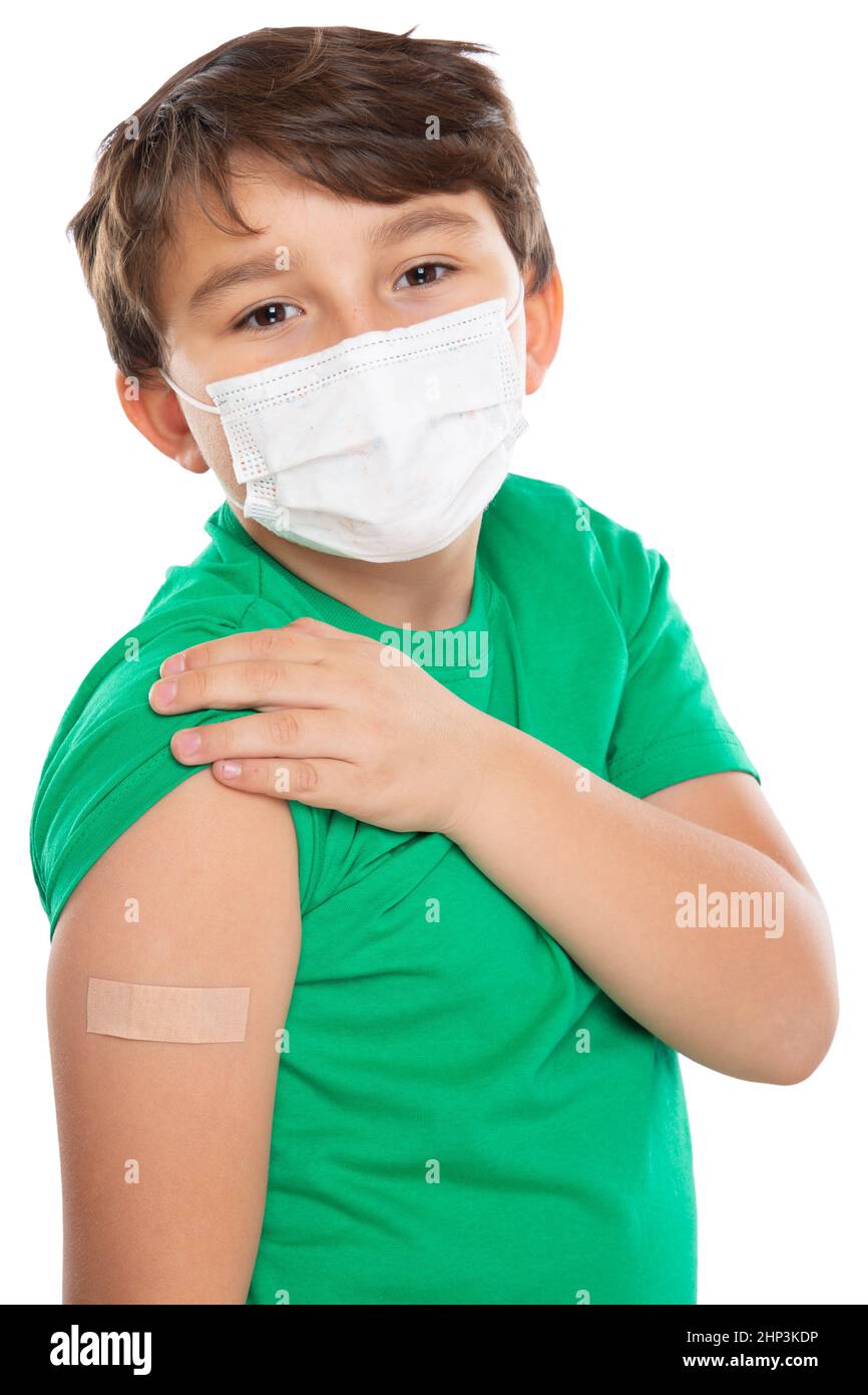 Child kid with plaster after Coronavirus vaccination wearing face mask against Corona Virus COVID-19 Covid isolated on white portrait format Stock Photo