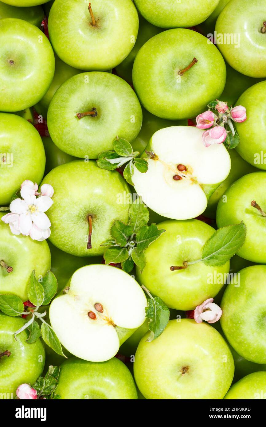Apples fruits green apple fruit background with leaves and blossoms portrait format organic Stock Photo