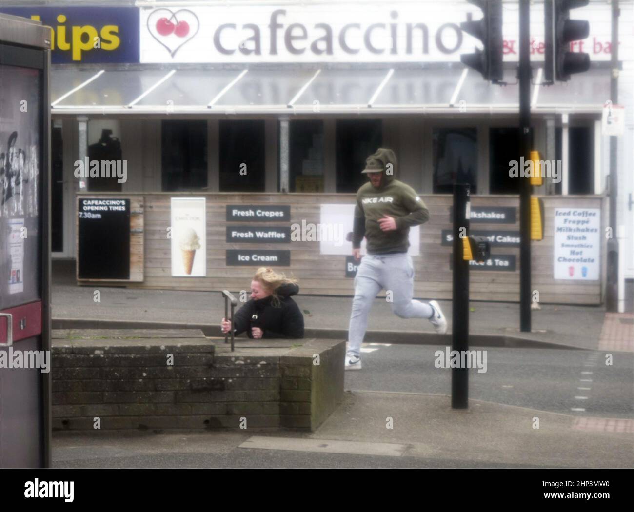 Newquay, UK. 18th February 2022. Eunice Red zone coastal town bears brunt of the storm. A woman was knocked down on the Narrowcliff road by severe wind and clung to a rail until passers by rushed to her aid, a team from Cornwall fire and Rescue were securing loose shop fronts nearby and seeing the situation dashed to take control.  Robert Taylor Alamy Live News Stock Photo