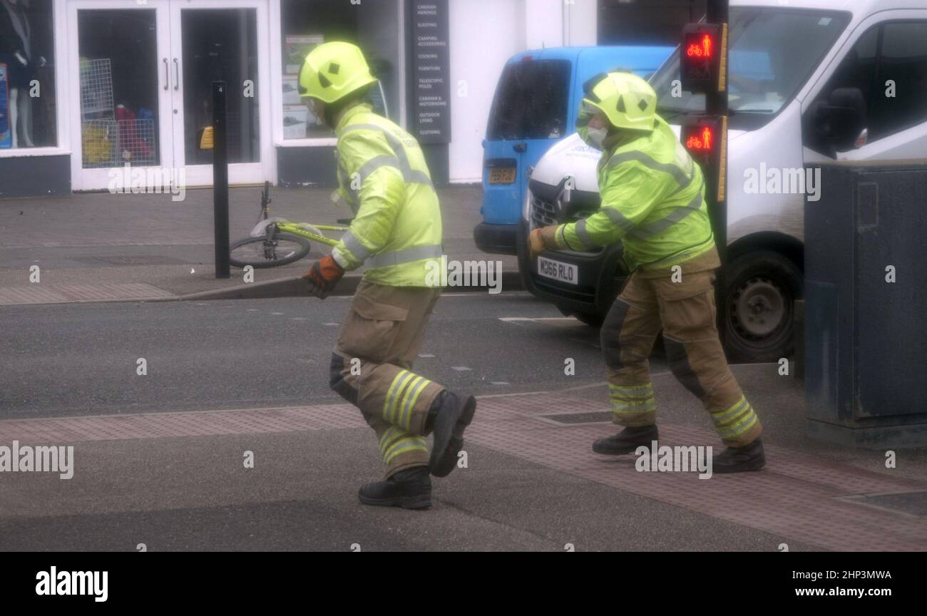 Newquay, UK. 18th February 2022. Eunice Red zone coastal town bears brunt of the storm. A woman was knocked down on the Narrowcliff road by severe wind and clung to a rail until passers by rushed to her aid, a team from Cornwall fire and Rescue were securing loose shop fronts nearby and seeing the situation dashed to take control.  Robert Taylor Alamy Live News Stock Photo