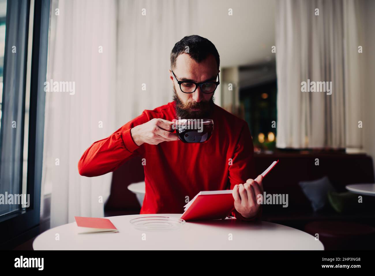 Man with notebook drinking tea during break Stock Photo