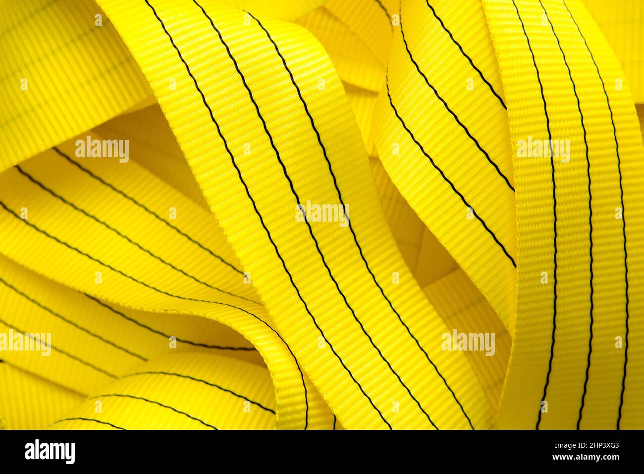 Industrial sewing machine sews a webbing sling. Manufacture of textile slings and tie straps