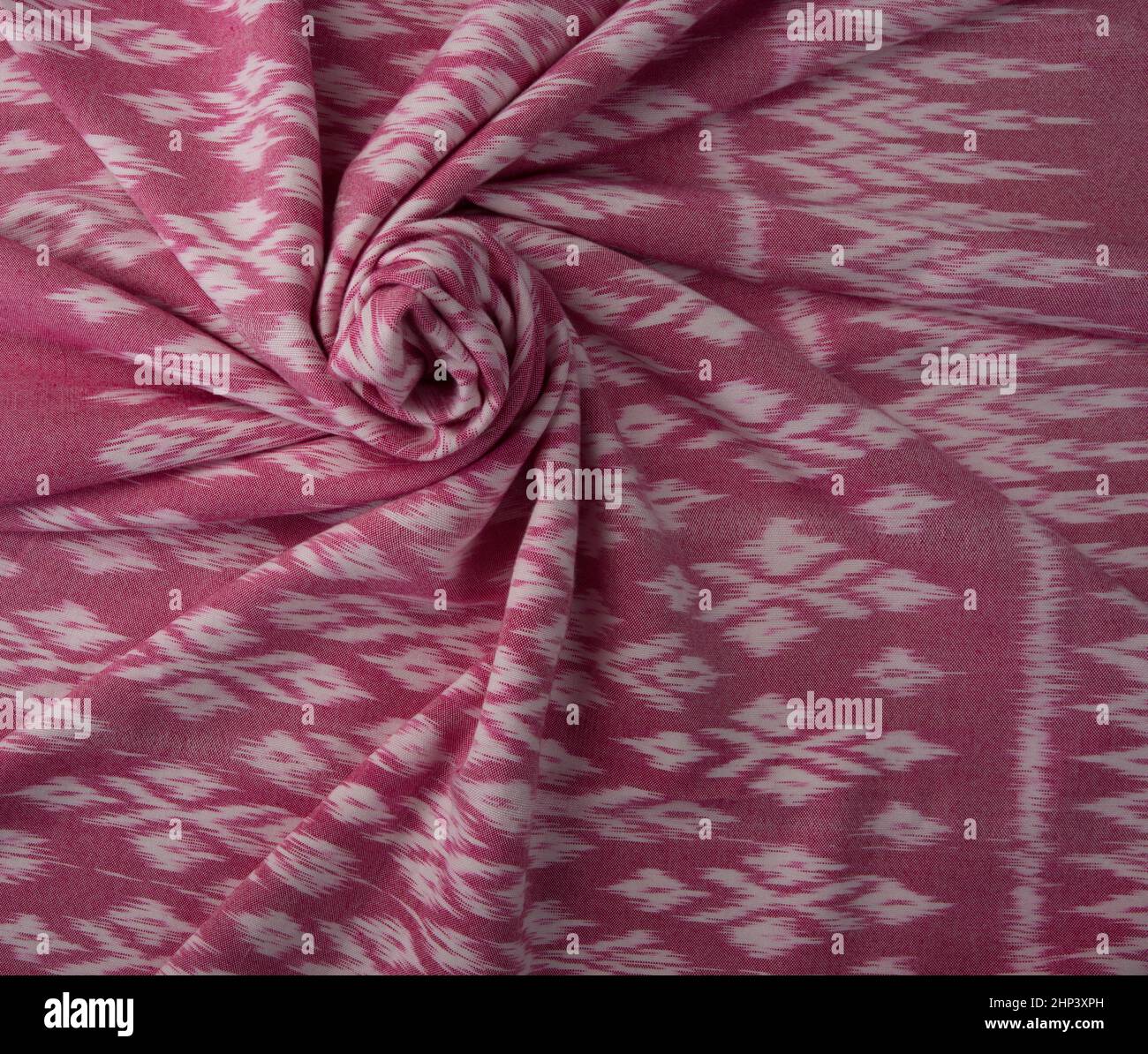 Close up of texture of pink color hand woven cotton fabric in Thai ancient style pattern. Stock Photo