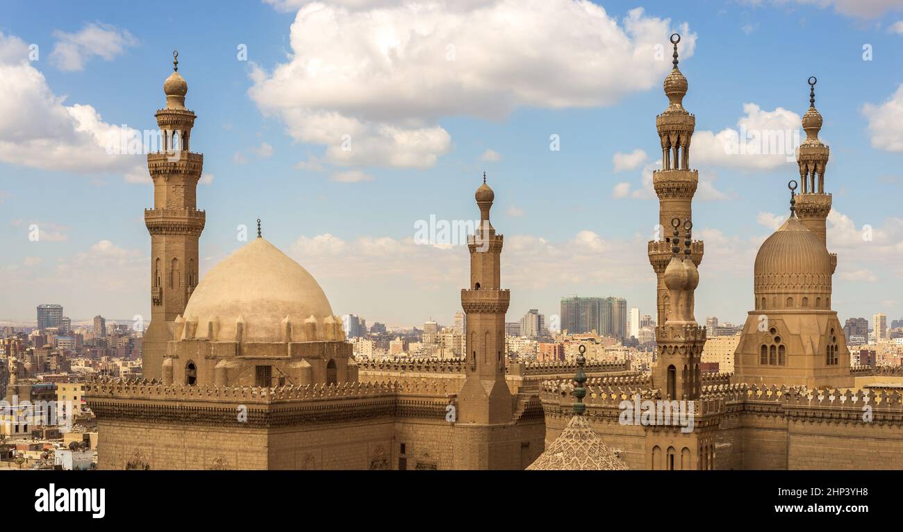 The Minarets and domes of Sultan Hassan Mosque and Al Rifai Mosque, Cairo, Egypt on a cloudy sky background Stock Photo
