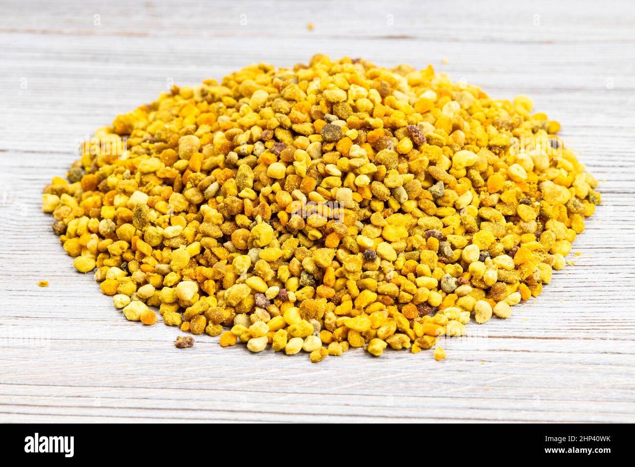pile of natural bee pollen close up on gray wooden board Stock Photo ...