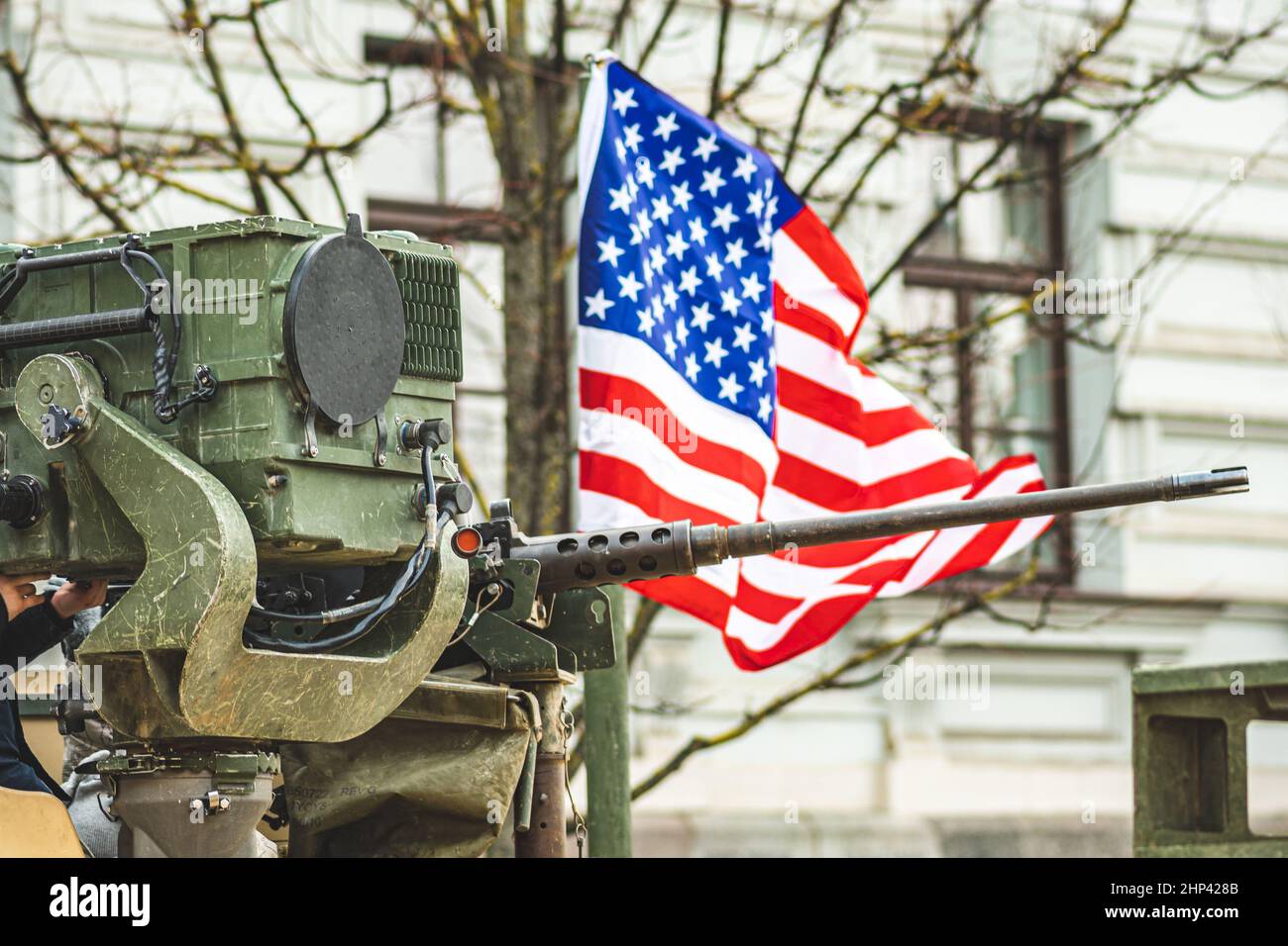 Machine gun mounted on United States Marine Corps forces tank or military vehicle, USA or US army, with American flag waiving on background Stock Photo