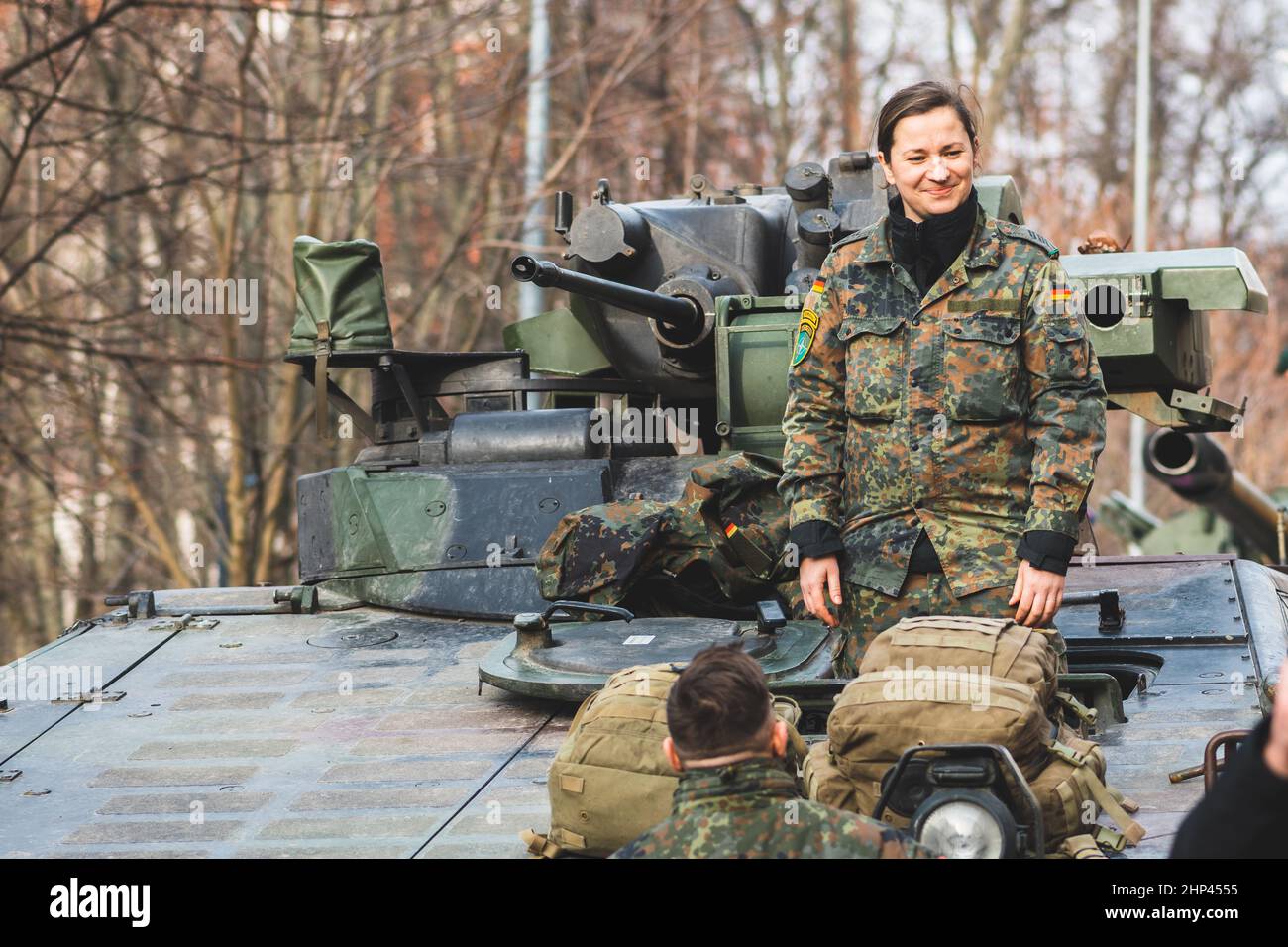 Armored crawler tank with cannon and female soldier smiling. German Army, member of NATO or North Atlantic Treaty Organization Stock Photo