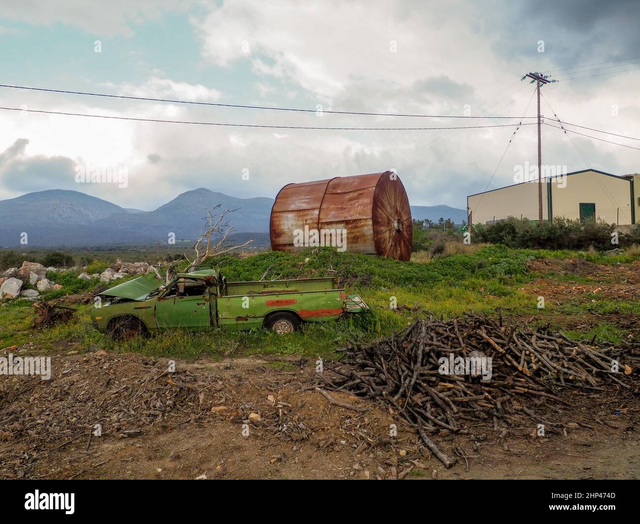 abandoned car with oil drum Stock Photo Alamy