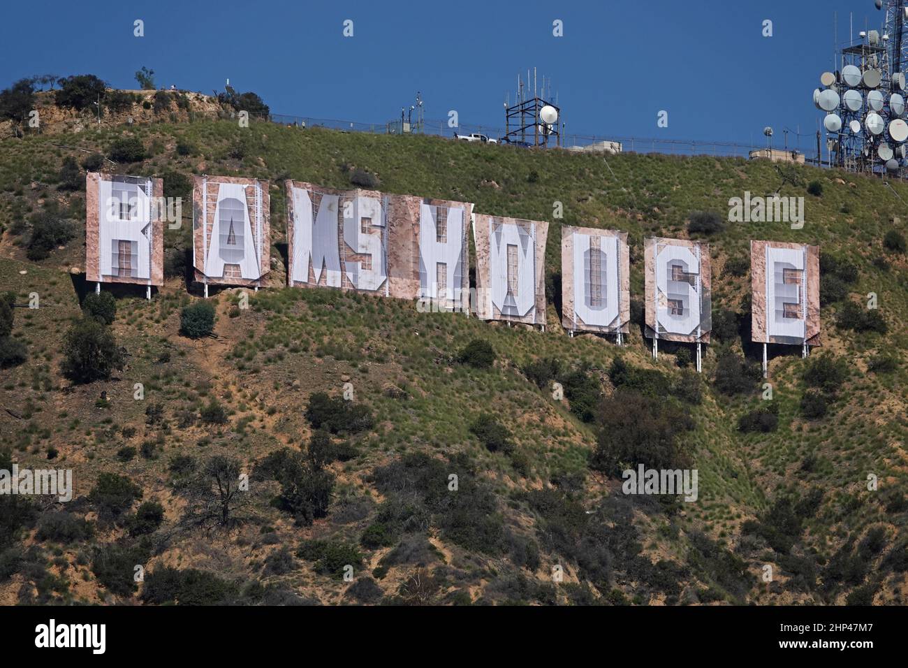 Hollywood, CA / USA - Feb. 16, 2022: Banners spelling out RAMS HOUSE are shown up close, covering the letters of the iconic Hollywood sign. Stock Photo