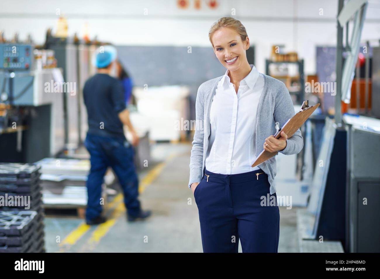 Focused on raising the bar each step of the way. A young manager looking confident while on the factory floor. Stock Photo