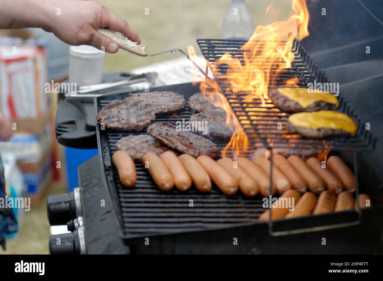 Hamburgers and Hotdogs cooking on BarBQ at Club cookout for kids and families Stock Photo Alamy